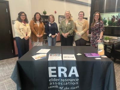 ERA Members at Meeting standing in front of a table
